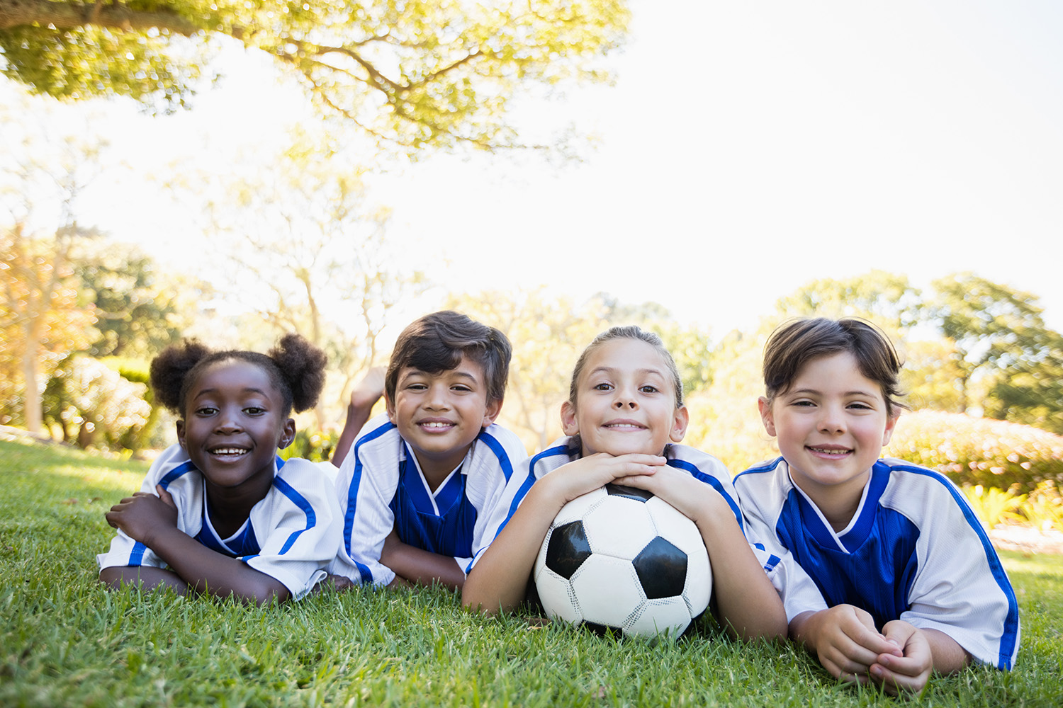 children-soccer-team-smiling-at-camera-while-lying-2025-10-28-21-50-09-utc